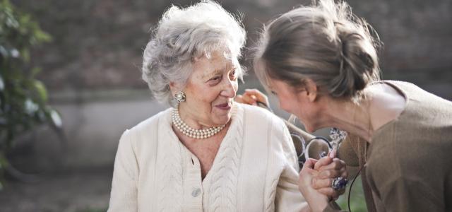 Elderly woman and younger woman having a conversation